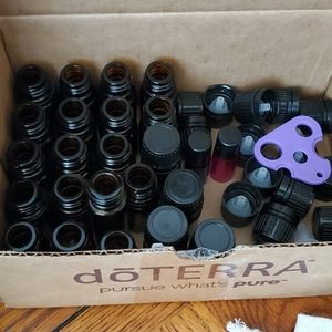 DoTerra unused bottles and lids and an opening tool.